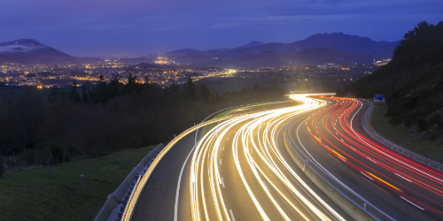 Vehicles driving on freeway at night 500