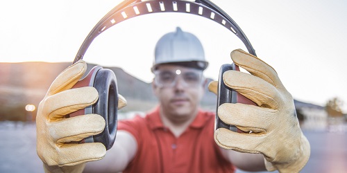 Photo of Worker Holding Up Ear Muffs