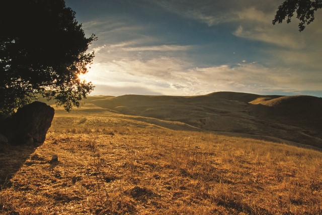 Sunrise over a hilly landscape