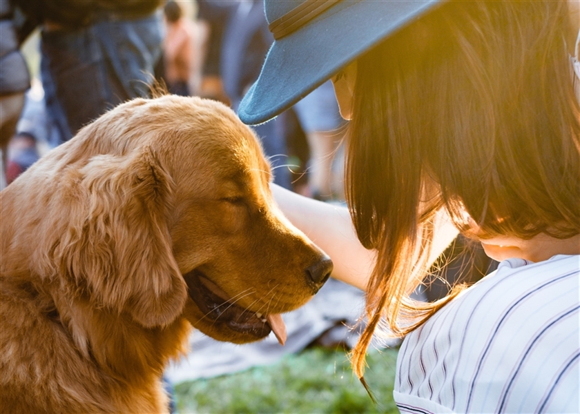 girl and dog with faces close together 