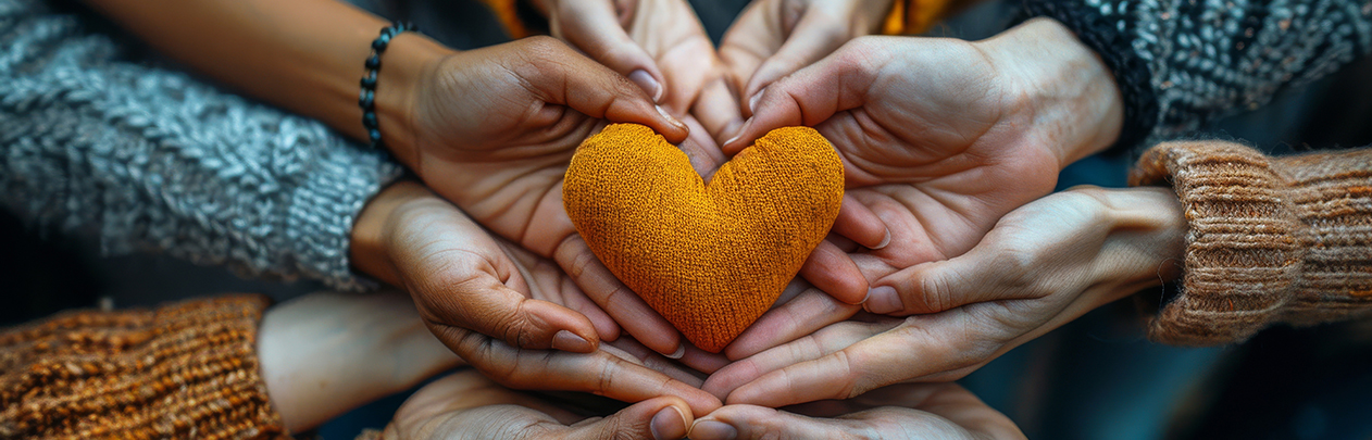 community of hands holding a heart