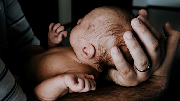 Dad holding newborn