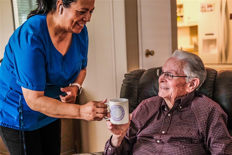 Older adult talking with her social worker outside