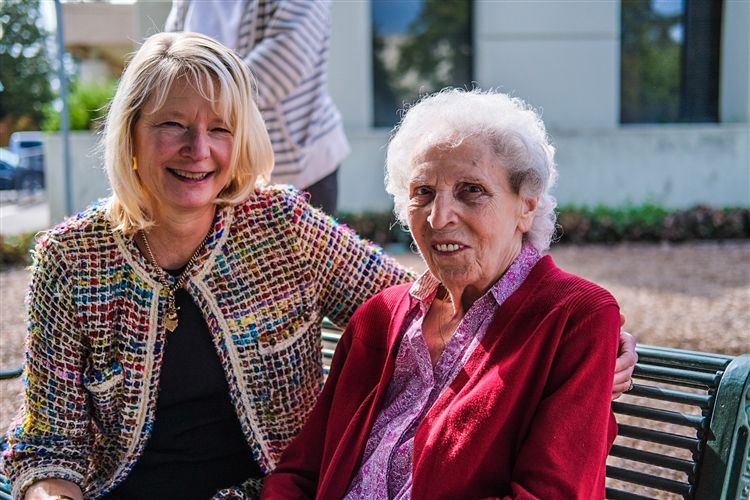 Older adult talking with her social worker outside